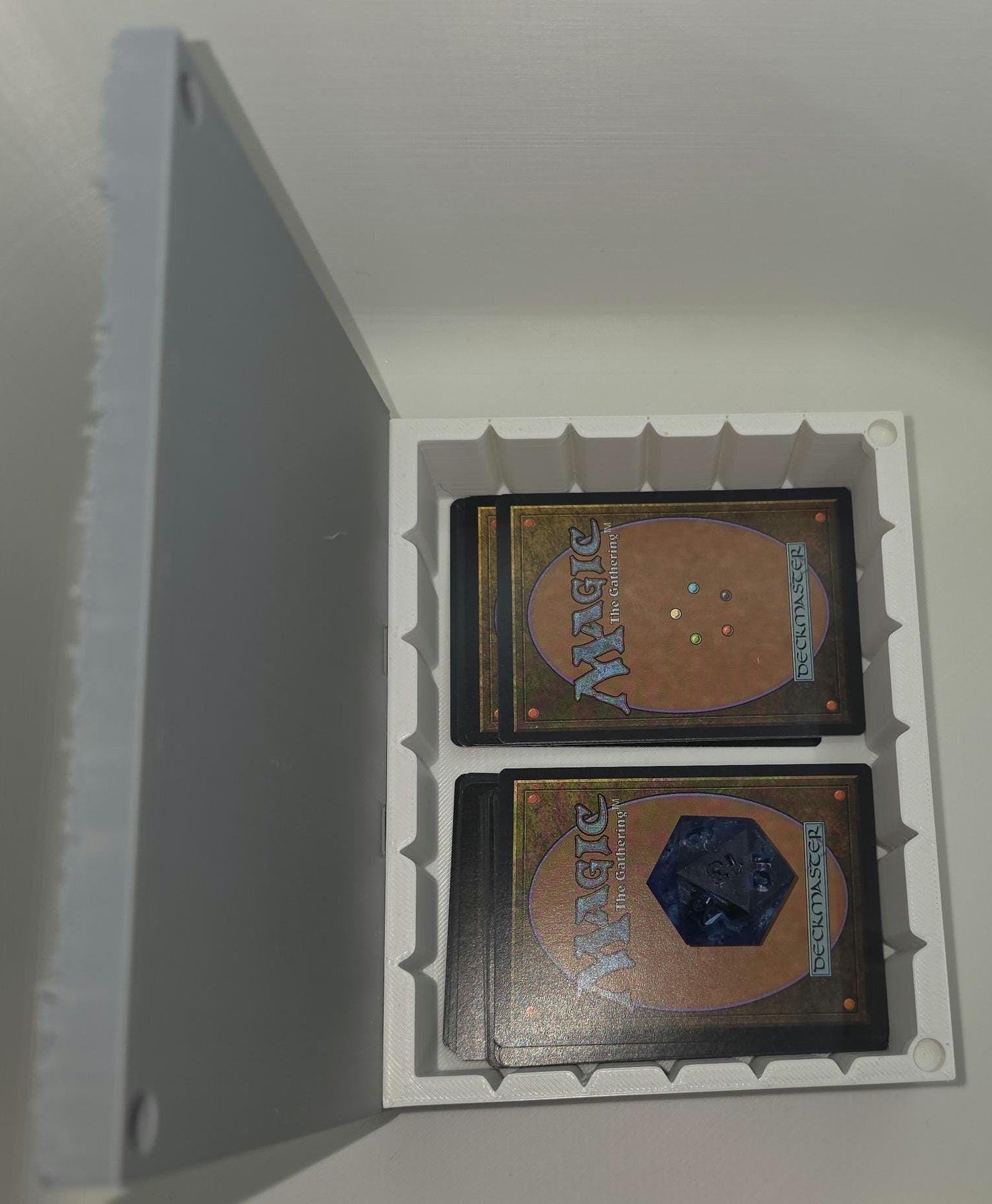 Two trading cards from 'Magic: The Gathering' in a protective holder against a white background