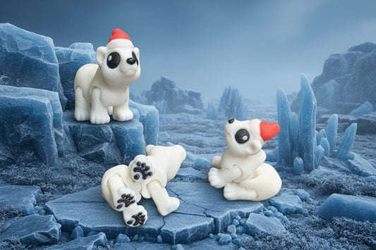 White polar bear figurines with red hats and hearts on a black surface.