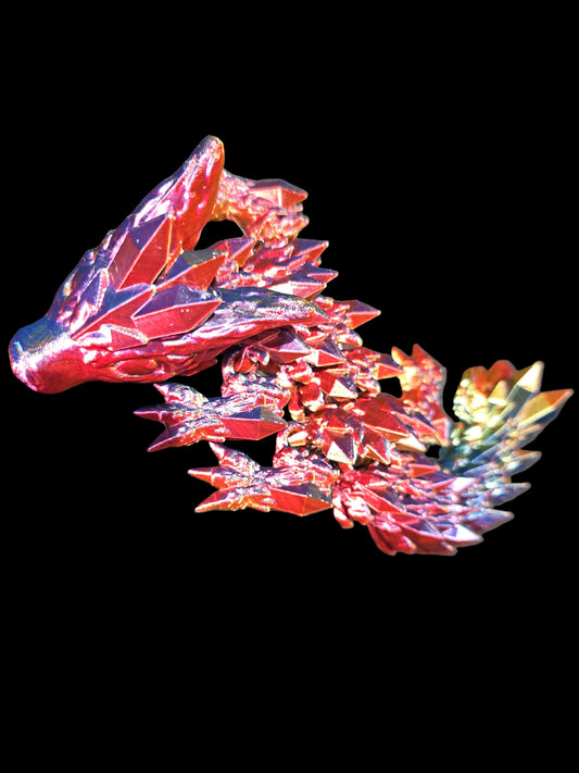 Colorful Crystal dragon-shaped toy on a dark surface